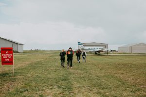 Group of people walking together towards an airplane