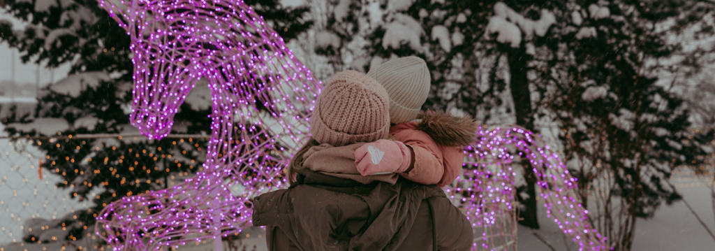 Woman and daughter looking at Christmas lights